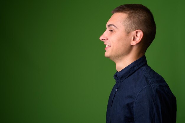 Portrait of young man looking away over white background