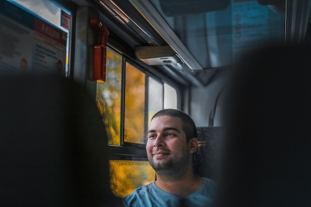 portrait of young man looking through window
