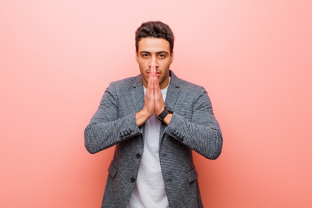 Portrait of a young man on a pink background