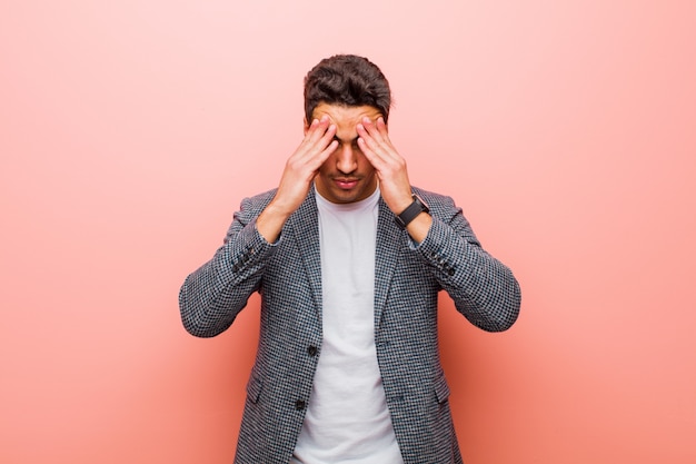 Portrait of a young man on a pink background