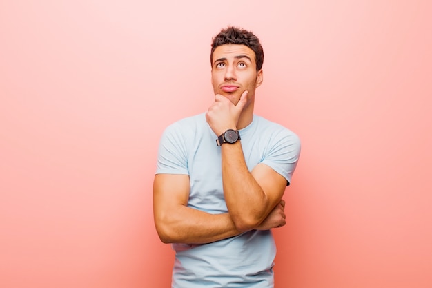 Portrait of a young man on a pink background