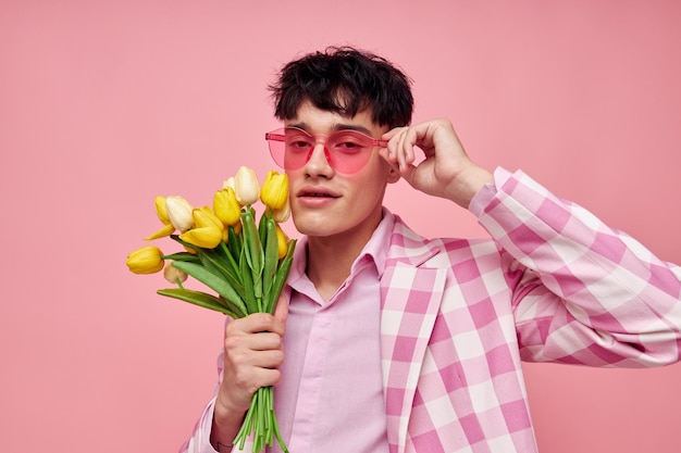 Portrait of a young man pink glasses checkered jacket fashion posing isolated background unaltered