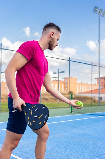 Portrait of a young man playing pickleball Young man going to perform the serve point in pickleball