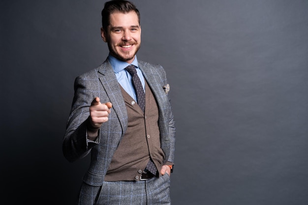 Portrait of young man pointing with his finger isolated