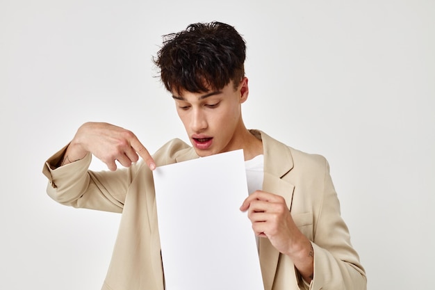 Portrait of a young man posing with a notepad in a suit isolated background unaltered