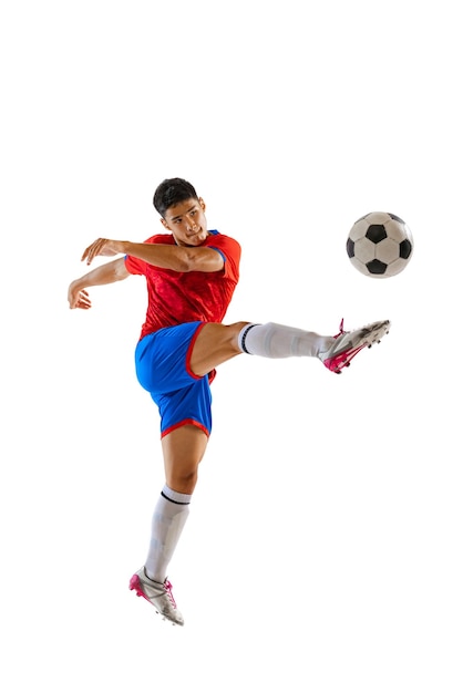 Portrait of young man professional football player training isolated over white studio background