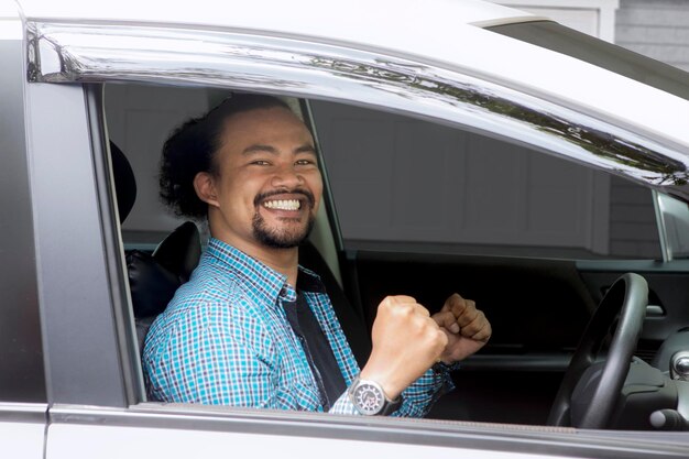 Portrait of young man sitting in car