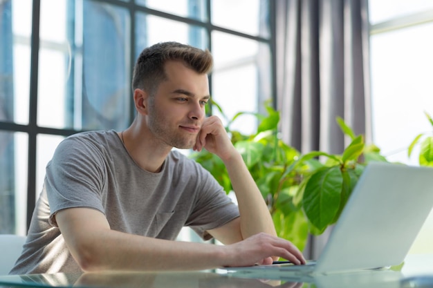 Portrait of young man sitting at his desk in the office