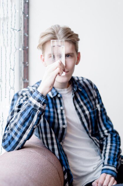 Portrait of young man sitting at home