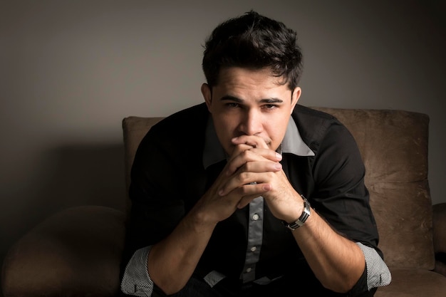 Portrait of young man sitting indoors