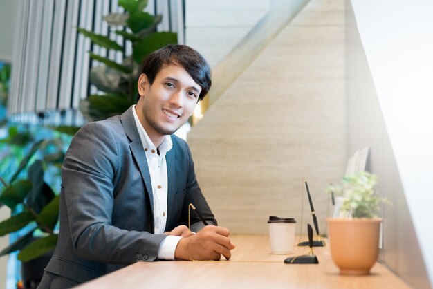 Portrait of young man sitting on table