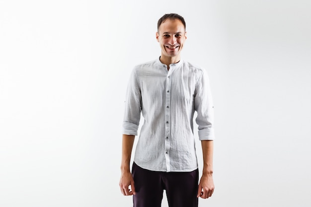 portrait of young man smiling against a white background