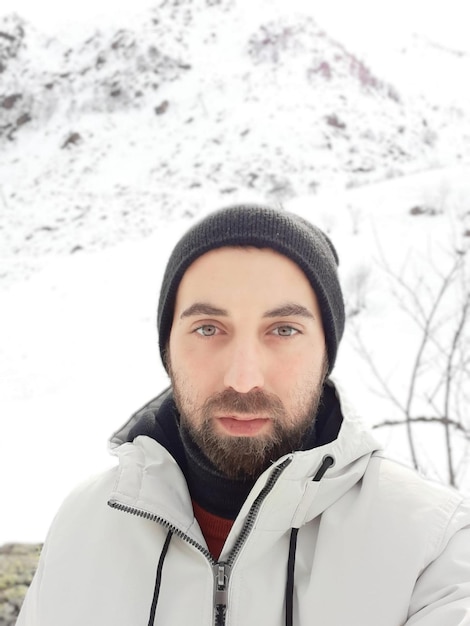 Portrait of young man in snow