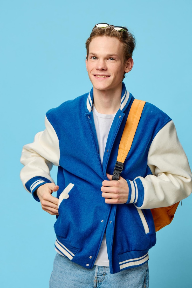 फोटो portrait of young man standing against blue background