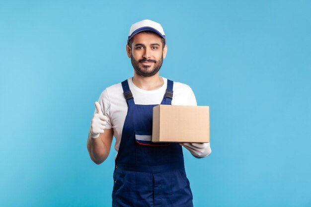 Portrait of young man standing against blue background