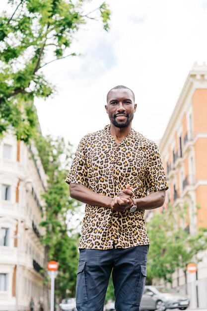 Portrait of young man standing against built structure