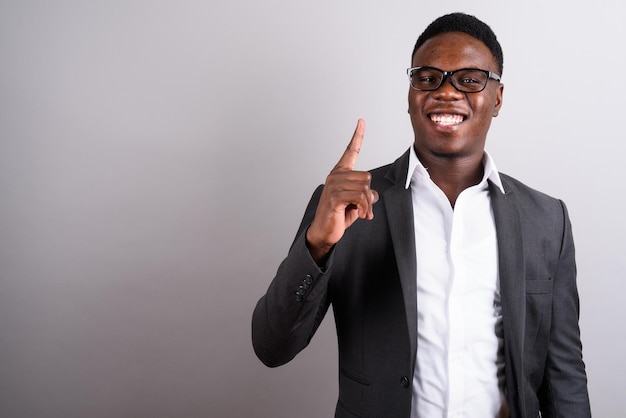 portrait of young man standing against gray background