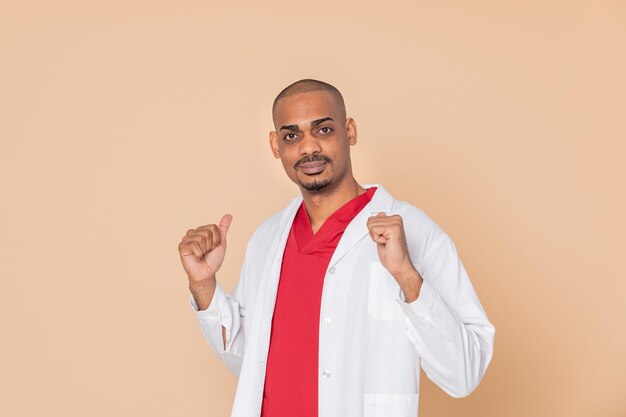 Portrait of young man standing against gray background