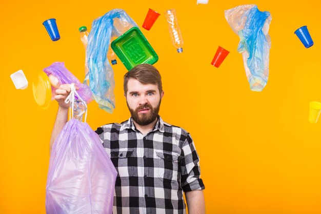 Portrait of young man standing against multi colored background