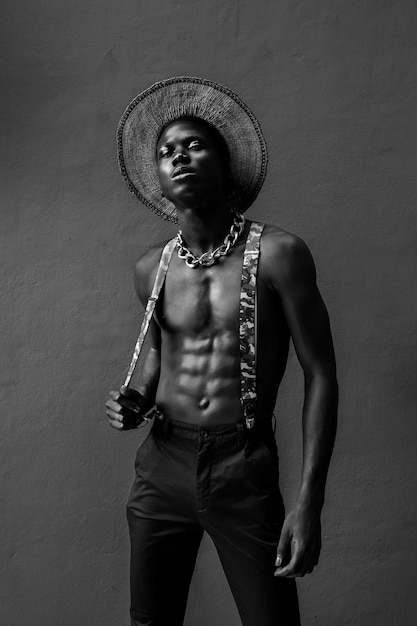 Portrait of young man standing against wall