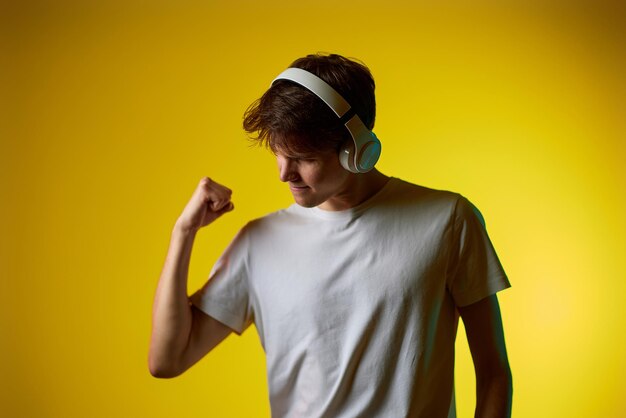 Portrait of young man standing against wall