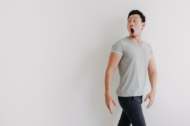 Portrait of young man standing against white background