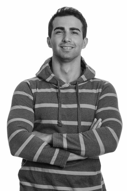 Portrait of young man standing against white background