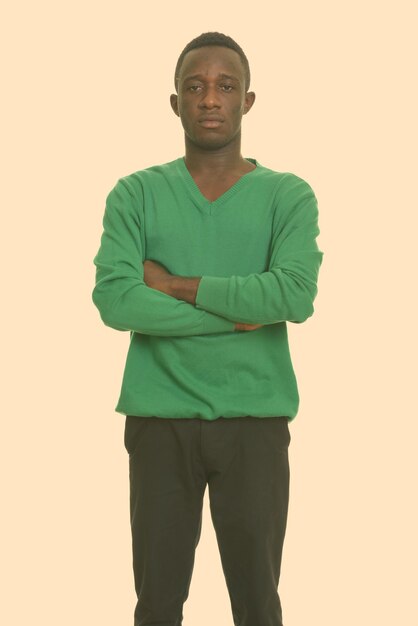 Portrait of young man standing against white background