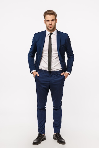 Portrait of young man standing against white background