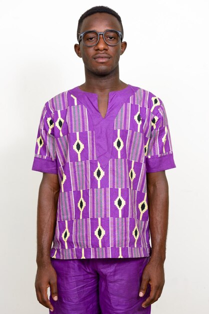 Portrait of young man standing against white background