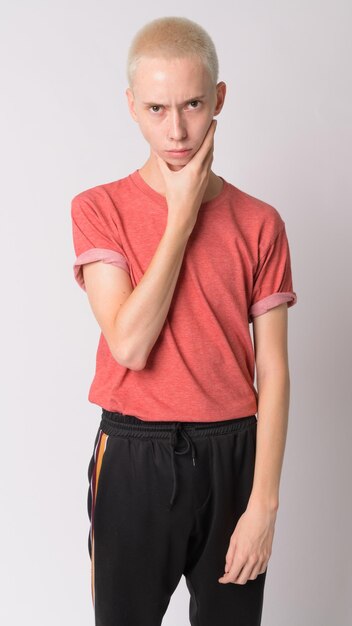 Portrait of young man standing against white background