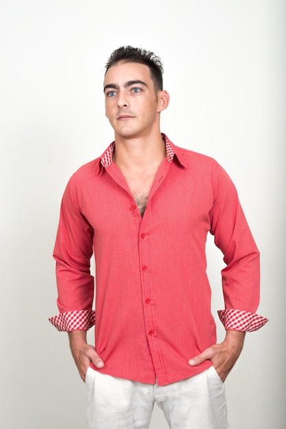 Portrait of young man standing against white background