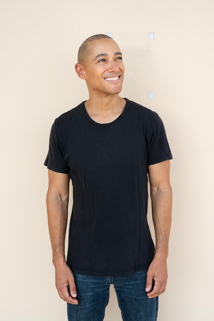 Portrait of young man standing against white background