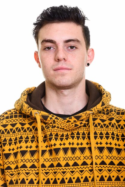 Portrait of young man standing against white background