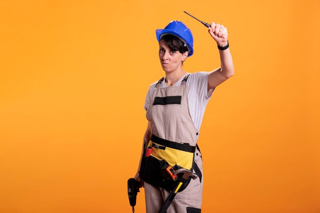 Portrait of young man standing against yellow background