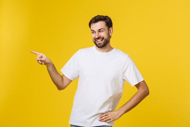 Portrait of young man standing against yellow background