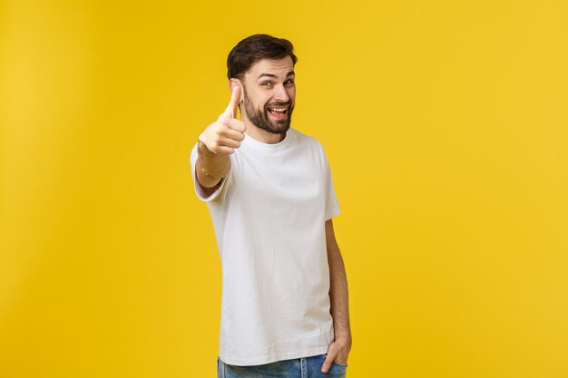 Portrait of young man standing against yellow background