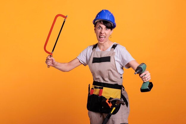 Portrait of young man standing against yellow background