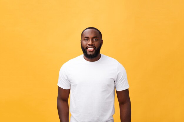 Portrait of young man standing against yellow background