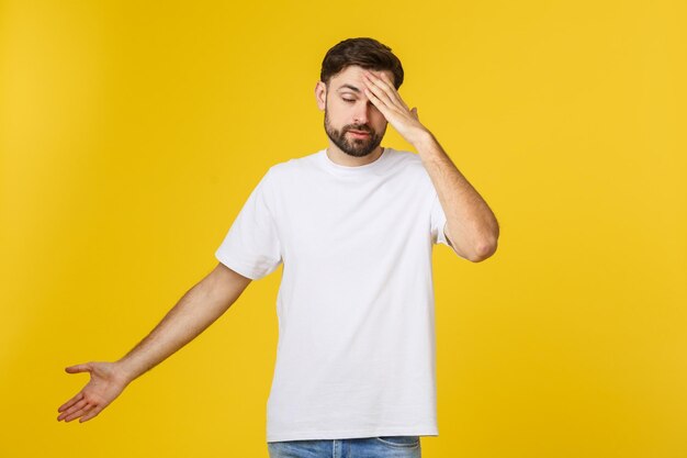 Portrait of young man standing against yellow wall