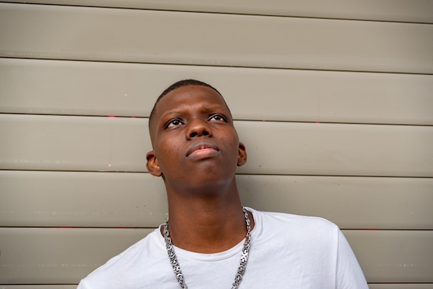 portrait of young man standing against yellow wall