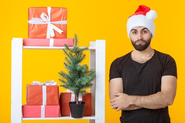 Portrait of young man standing against yellow wall