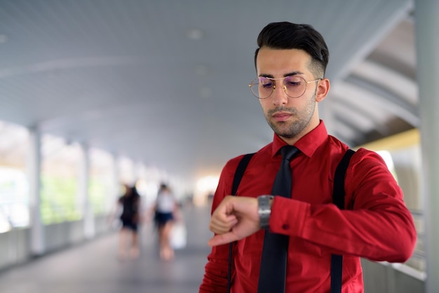 Portrait of young man standing at home