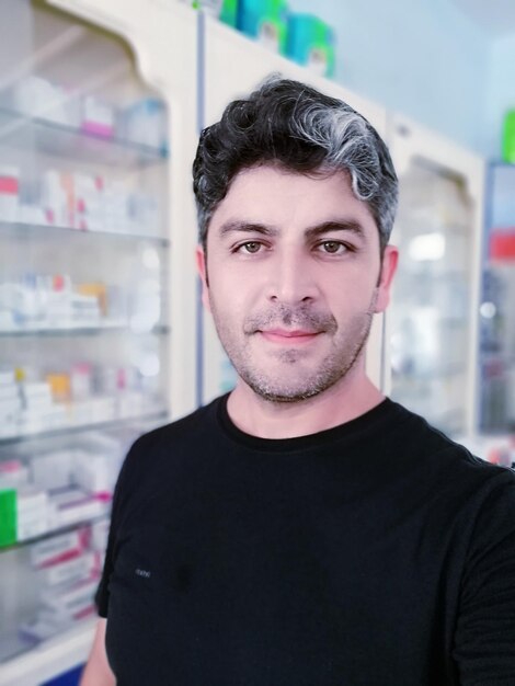 Portrait of young man standing in store