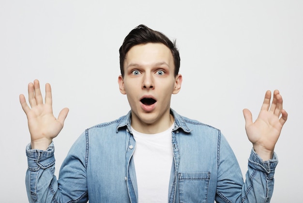 Portrait of a young man surprised face expression