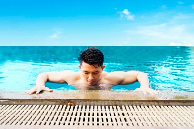 Portrait of young man on the swimming pool