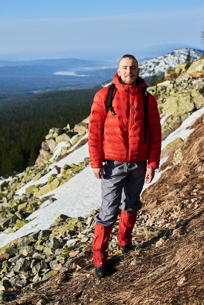 Portrait of a young man on top of a mountain