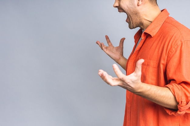 Portrait of young man unhappy angry mad aggressive quarrel\
problem scream isolated over white grey background