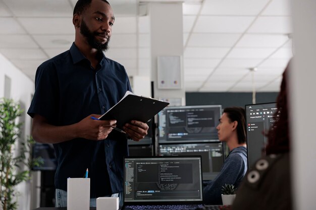 Portrait of young man using digital tablet in office