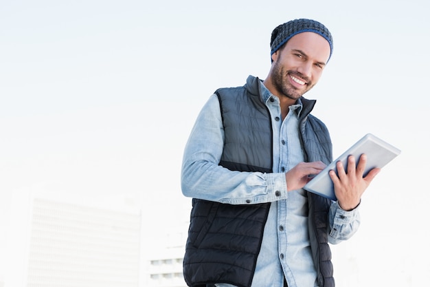 Portrait of young man using digital tablet